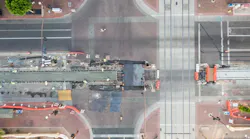An aerial image shows the new construction streetcar track edging closer to the existing light-rail track.