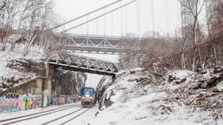 An Empire Service train passes under the George Washington Bridge in Manhattan. An Empire Service train passes under the George Washington Bridge in Manhattan.
