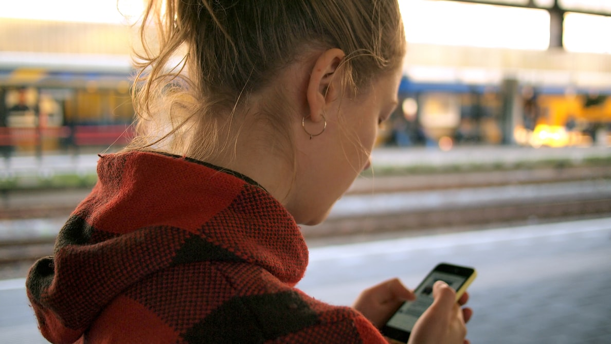 Daria Nepriakhina Unsplash Woman On Phone At Train Station