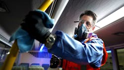 Wearing protective clothing due to the use of cleaning agents in a confined space, a Metrolinx crew member wipes down the inside of a GO bus in this March 2, 2020 image. Wearing protective clothing due to the use of cleaning agents in a confined space, a Metrolinx crew member wipes down the inside of a GO bus in this March 2, 2020 image.