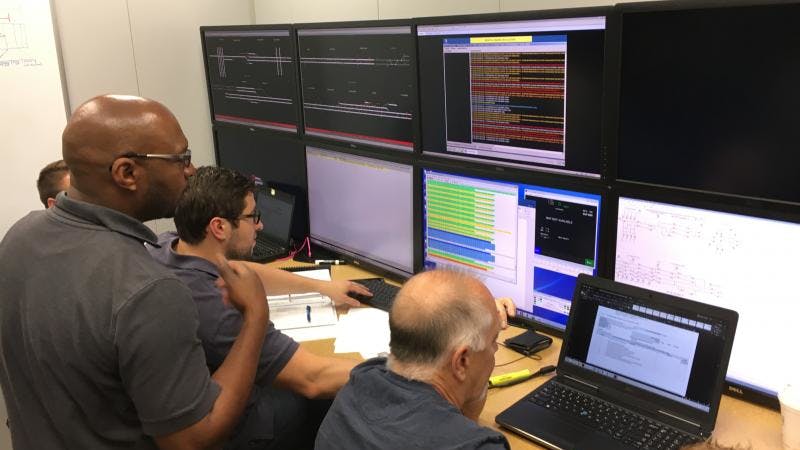 Engineers monitor performance of the communications between the train and the PTC system during a simulated train run in Metra&rsquo;s PTC lab.