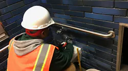 A BART crew member works on the demolition of the restroom at the 19th Street Station.