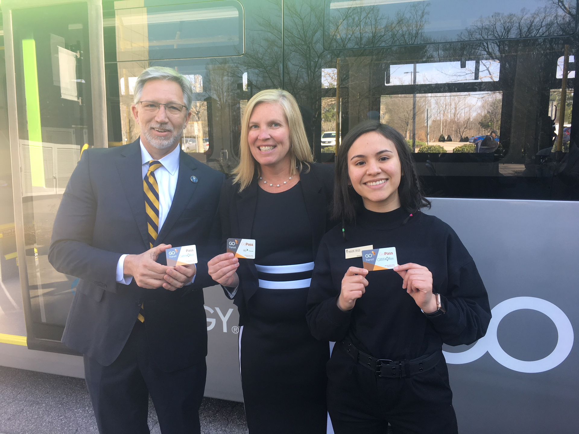 Wake Tech President Scott Ralls, interim GoTriangle CEO and President Shelley Blake Curran and Wake Tech Student Body President Nicole Castillo show off their GoPasses.