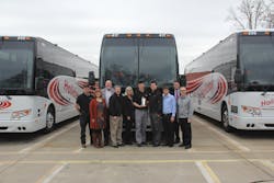 Holiday Tours team members celebrate the company&apos;s 100th Prevost coach purchase.