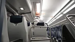 An NJ Transit employee cleans a train interior. Transit agency staff and riders will be required to wear face coverings while onboard vehicles and NJ Transit says it will continue its sanitization practices.