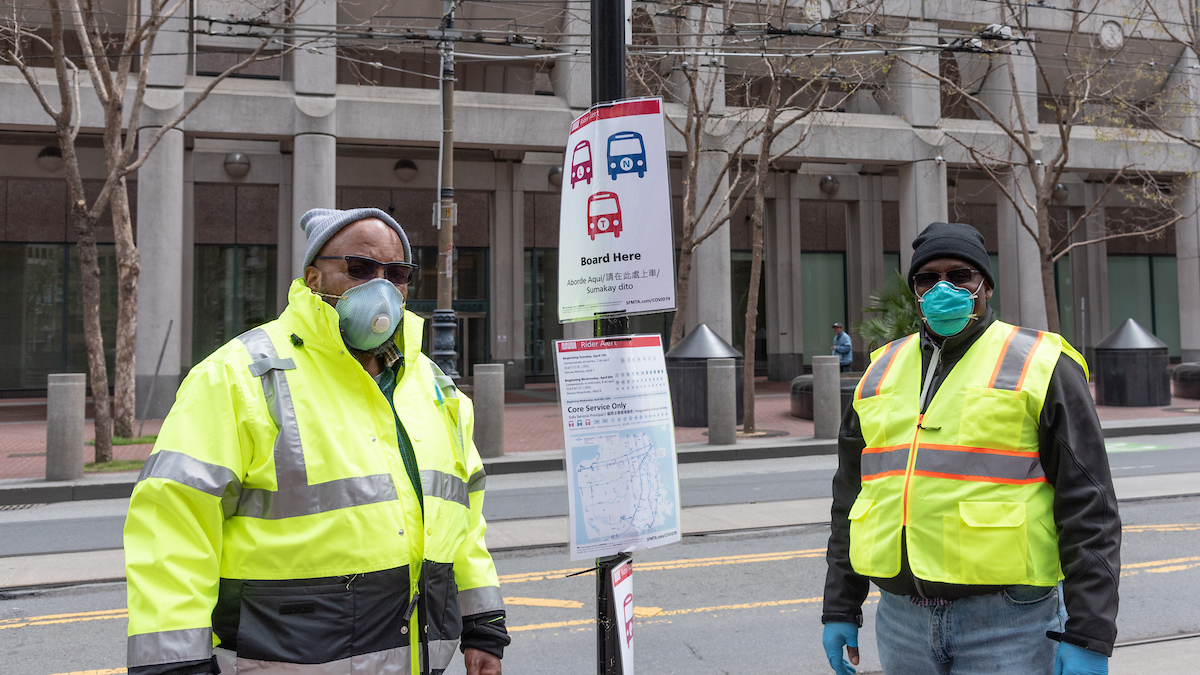 COVID-19 ambassadors at a bus stop on Market Street.