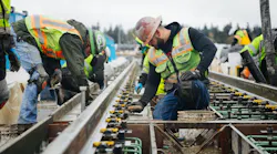 Crews install the rail at the Northgate Station.