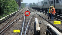 This photo illustration depicts the accident scene on June 11, 2017.The photo was taken at track level from the east end of the Queens Village Station. The point where the roadway worker was struck by the train is marked with the red circle.