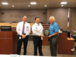 Rene' Alvarez, general manager, Transdev Transportation, presents a plaque to Martin Tomkins, COO, AVTA, and Macy Neshati, CEO AVTA. Rene' Alvarez, general manager, Transdev Transportation, presents a plaque to Martin Tomkins, COO, AVTA, and Macy Neshati, CEO AVTA.