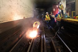 A crew member uses a torch to cut rail near Bowdoin Station. A crew member uses a torch to cut rail near Bowdoin Station.