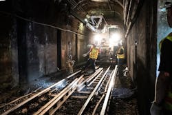 Crew members unload new rail from a swing loader for track replacement on the Blue Line near Bowdoin. Crew members unload new rail from a swing loader for track replacement on the Blue Line near Bowdoin.
