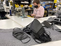 A mask is sewn at Freedman Seating. The company started producing masks for employees when PPE supplies were being reserved for essential workers.