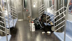An image from January showing an unsheltered individual on the E train. An image from January showing an unsheltered individual on the E train.