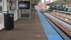 The decals, spaced six feet apart, serve as guides for how far apart customers should stand to ensure proper social distancing. The decals, spaced six feet apart, serve as guides for how far apart customers should stand to ensure proper social distancing.