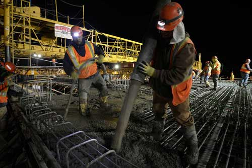 Met Council Workers pour concrete on the bridge where the Lake Street Station of the Orange Line will be built.