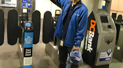 A street team member distributes free face coverings at the newly reopened Granville Station in Metro Vancouver