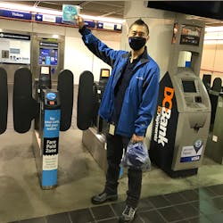 A street team member distributes free face coverings at the newly reopened Granville Station in Metro Vancouver A street team member distributes free face coverings at the newly reopened Granville Station in Metro Vancouver