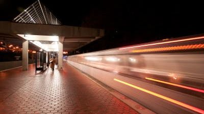 A train leaves Grosvenor Station in Maryland heading towards Washington, D.C., at night.