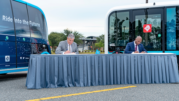 Left, FSCJ President Dr. John Avendano and JTA CEO Nathaniel P. Ford, Sr., sign an MOU that will expand JTA’s autonomous vehicle Test & Learn program on FSCJ’s Cecil Center Campus.