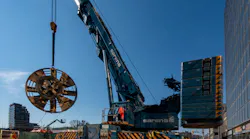 The 6-metre (19.7-foot) long cutter head from one of the tunnel boring machines used on the Eglinton Crosstown subway project is lifted from deep underground.