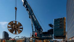 The 6-metre (19.7-foot) long cutter head from one of the tunnel boring machines used on the Eglinton Crosstown subway project is lifted from deep underground.