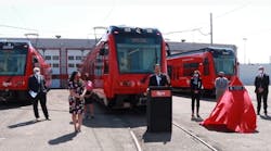 MTS Board Chair Nathan Fletcher, flanked by San Diego transportation leaders and California Transportation Commission Chair Hilary Norton (right of podium) delivers remarks at dedication ceremony for the final trolley car.
