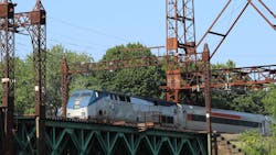 A Metro-North train moving across the Walk Bridge. A Metro-North train moving across the Walk Bridge.