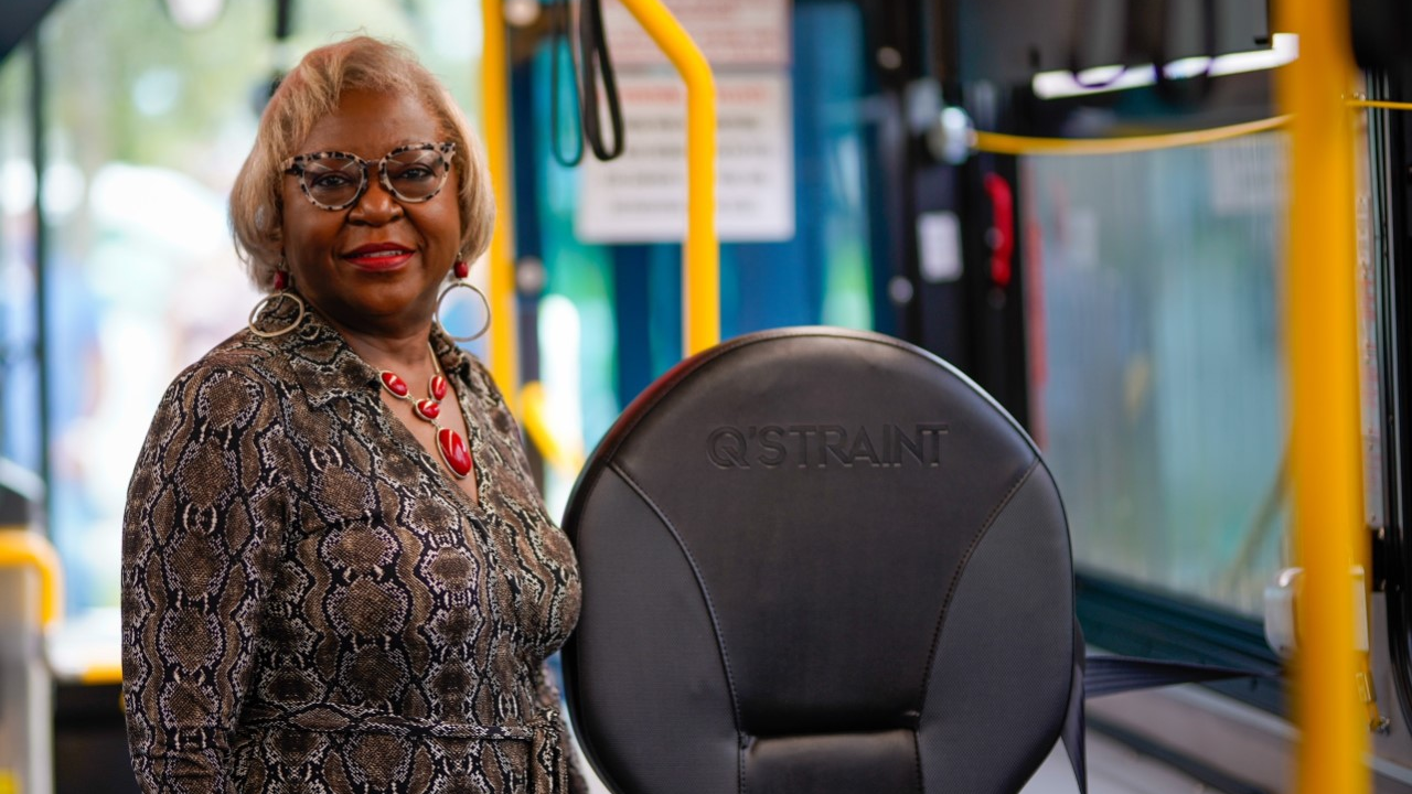 Palm Beach County Administrator Verdenia Baker shows one of the new wheelchair securement devices.