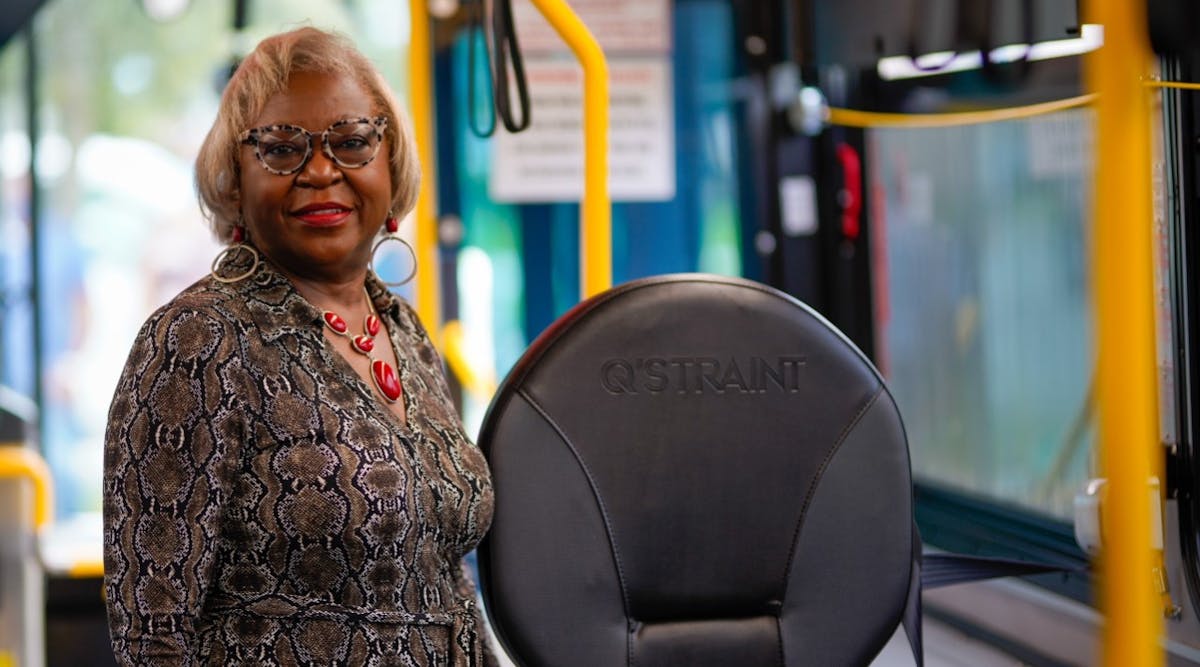 Palm Beach County Administrator Verdenia Baker shows one of the new wheelchair securement devices.