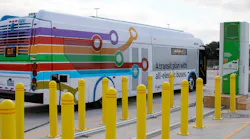 A New Flyer bus is charged using a Proterra charger.