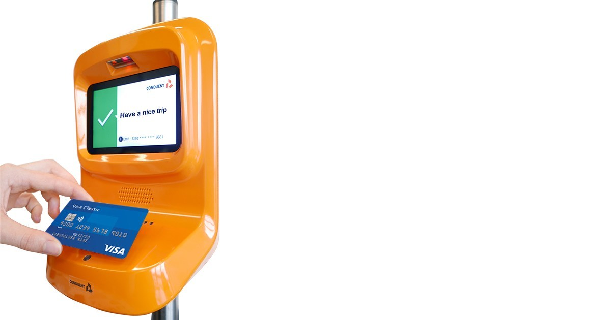 Passenger paying for travel with contactless Visa card.