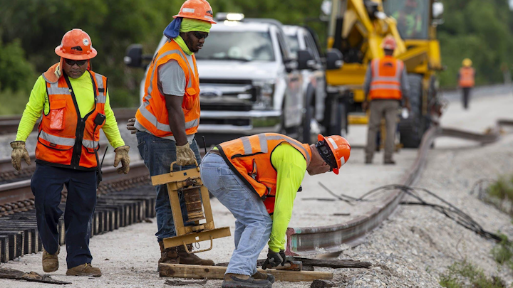 Brightline construction crews position a rail north of Hood Road in Palm Beach Gardens, Friday, August 7, 2020. Brightline is adding a second set of tracks for their planned expansion to Orlando.