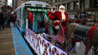 Santa Claus rides the Allstate Chicago Transit Authority Holiday Train as it runs on the Green Line in Chicago on Friday, Nov. 29, 2019.