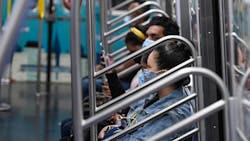 New York City Transit subway riders in face coverings. New York City Transit subway riders in face coverings.