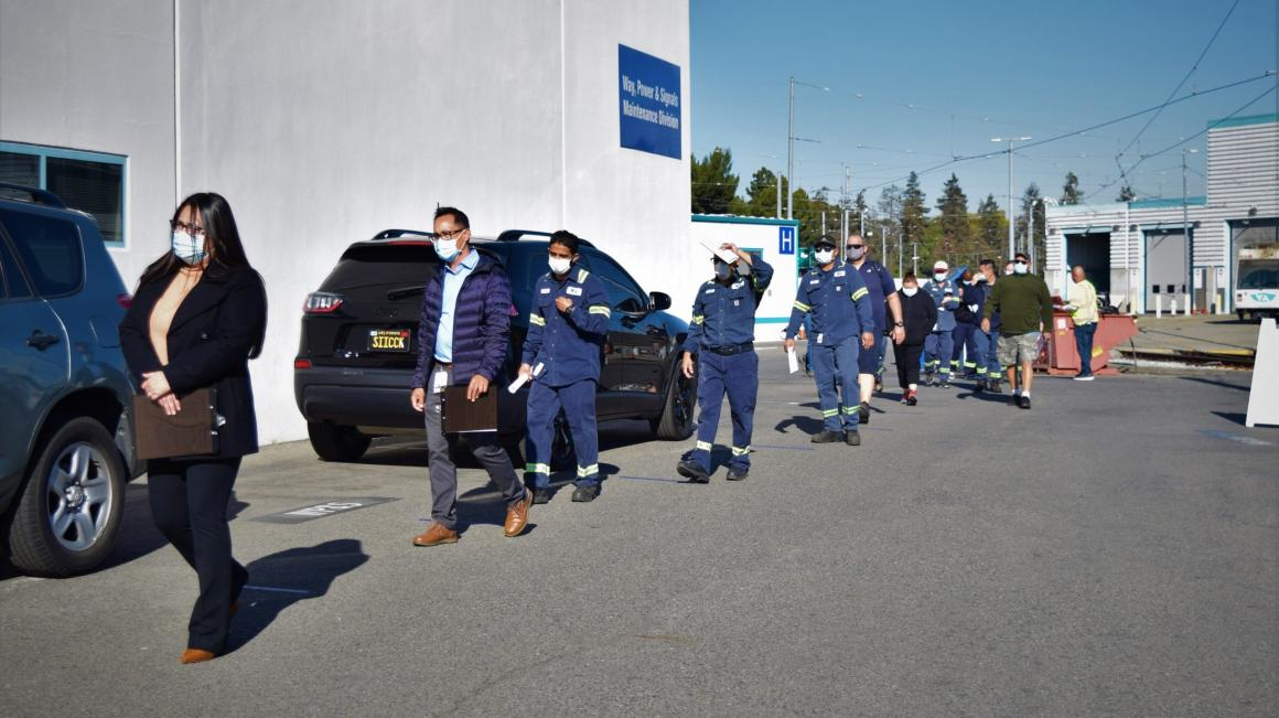 Santa Clara VTA employees line up at the Guadalupe Light Rail Division, in San Jose, Calif., for COVID-19 testing.