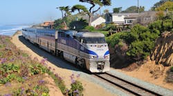 An Amtrak train traveling along tracks that are situated on the Del Mar Bluffs along the LOSSAN Corridor in southern California.