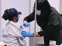 An MTA transit employee receives the COVID-19 vaccine at the Javits Center.