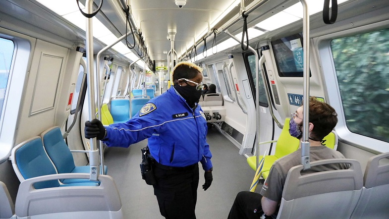 Ambassador Sequoia Taylor talks with a customer on a train.