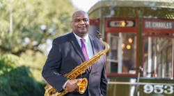 Alex Wiggins. RTA CEO, New Orleans Native and saxophone musician, poses with his saxophone on the Historic St. Charles Streetcar alignment.