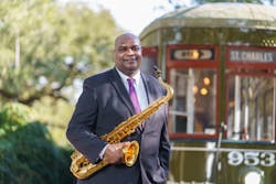 Alex Wiggins. RTA CEO, New Orleans Native and saxophone musician, poses with his saxophone on the Historic St. Charles Streetcar alignment.