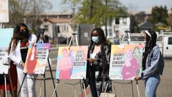 Youth activists Rexy, Uche, and Victoria with posters at launch of Not One More Girl campaign. Youth activists Rexy, Uche, and Victoria with posters at launch of Not One More Girl campaign.