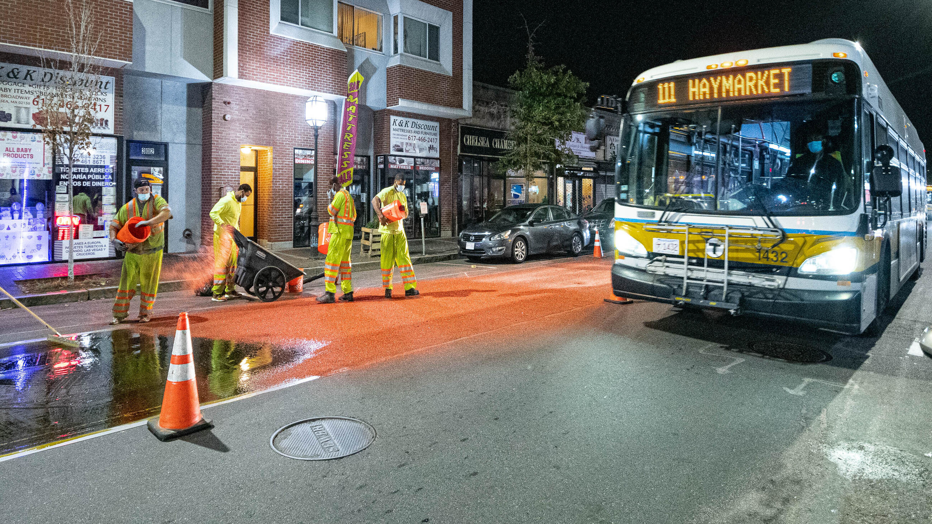 Construction crews installing bus lane markings on Broadway in Chelsea on October 21, 2020.