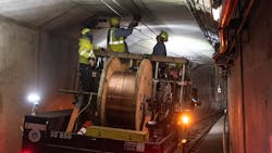 SFMTA crew installing new overhead wire in the subway tunnel.