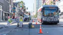 Paint shop crew removing old pavement markings for installation of temporary emergency transit only lanes.