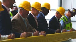 Officials from the community, Brightline and project workers signed a stick of rail to commemorate the halfway construction point.