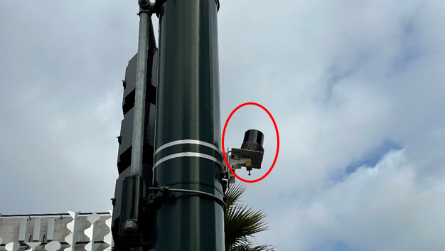 Sensor mounted on a traffic signal pole.