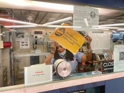 Shanica Godfrey, a station booth agent at the Columbus Circle station, removes an overnight closure sign. Shanica Godfrey, a station booth agent at the Columbus Circle station, removes an overnight closure sign.