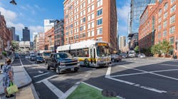 Two Route 111 buses travel along a congested stretch of North Washington Street near Causeway Street in Boston before construction of a northbound bus lane.