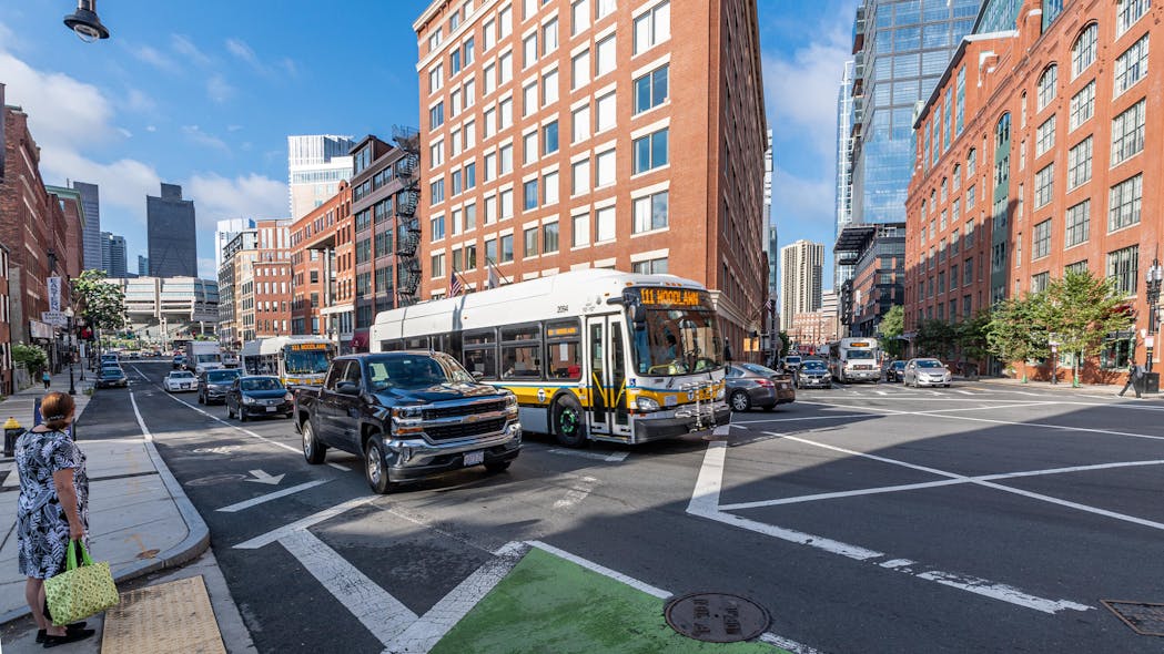 Two Route 111 buses travel along a congested stretch of North Washington Street near Causeway Street in Boston before construction of a northbound bus lane.