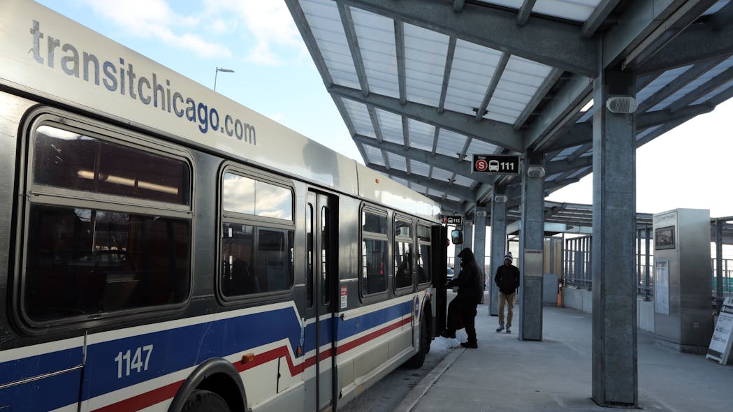 Riders board a bus at the CTA Red Line station at 95th Street in Chicago on Feb. 8, 2019.